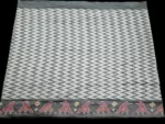 Close-up of a handwoven semi-silk Pochampally saree showing vibrant ikat diamond and temple motifs on a broad border