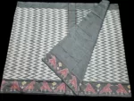 Close-up of a handwoven semi-silk Pochampally saree showing vibrant ikat diamond and temple motifs on a broad border
