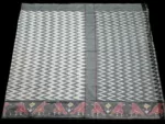 Close-up of a handwoven semi-silk Pochampally saree showing vibrant ikat diamond and temple motifs on a broad border
