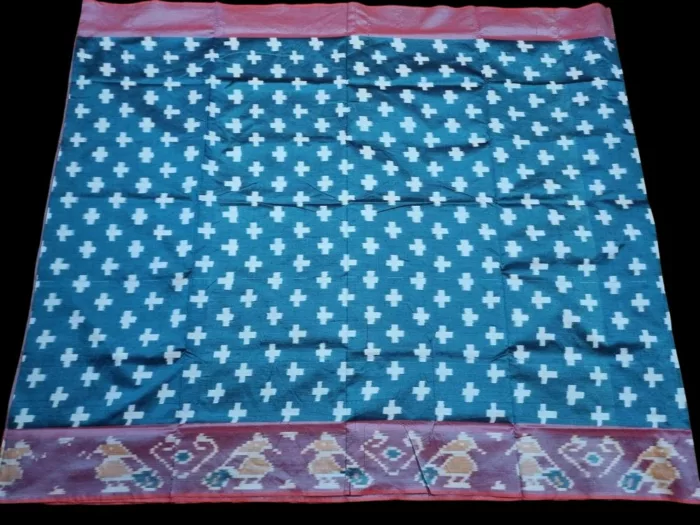 Close-up of a handwoven semi-silk Pochampally saree showing vibrant ikat diamond and temple motifs on a broad border