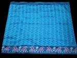 Close-up of a handwoven semi-silk Pochampally saree showing vibrant ikat diamond and temple motifs on a broad border