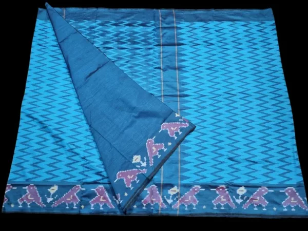 Close-up of a handwoven semi-silk Pochampally saree showing vibrant ikat diamond and temple motifs on a broad border