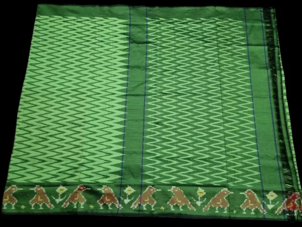 Close-up of a handwoven semi-silk Pochampally saree showing vibrant ikat diamond and temple motifs on a broad border