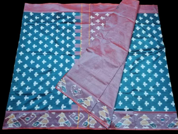 Close-up of a handwoven semi-silk Pochampally saree showing vibrant ikat diamond and temple motifs on a broad border