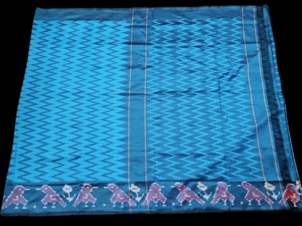 Close-up of a handwoven semi-silk Pochampally saree showing vibrant ikat diamond and temple motifs on a broad border