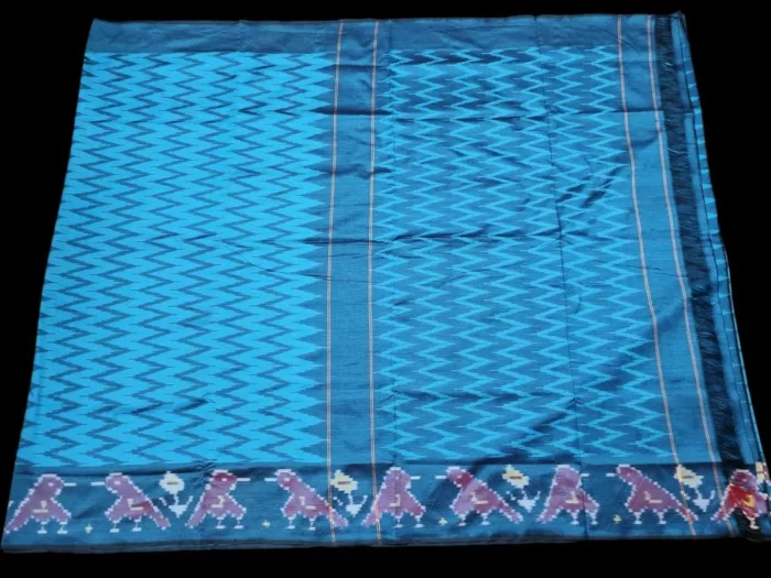 Close-up of a handwoven semi-silk Pochampally saree showing vibrant ikat diamond and temple motifs on a broad border