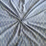 Handwoven ikat cotton fabric in vibrant tie-dye pattern