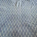 Handwoven ikat cotton fabric in vibrant tie-dye pattern