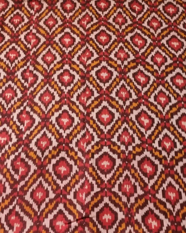 Handwoven Pochampally ikat fabric with red, mustard, and white diamond pattern, traditional geometric design on cotton or cotton-silk textile.